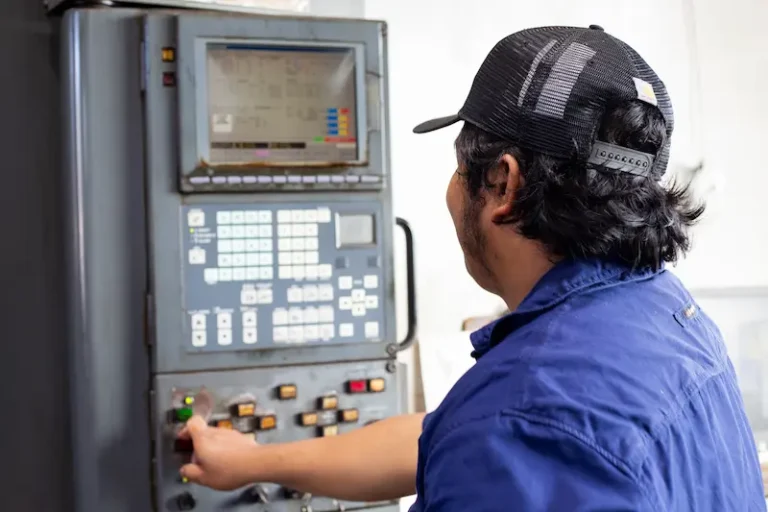 CNC machine operator setting up a program for a CNC turning machine